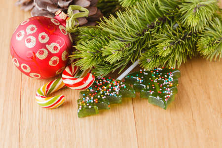 New year decoration on wood table with pine, sweets and red starsの写真素材