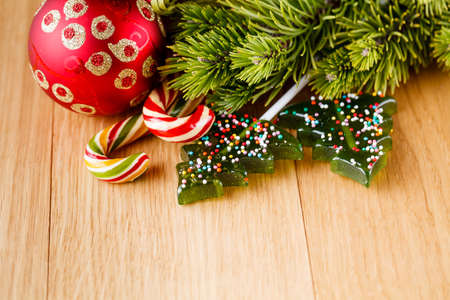 New year decoration on wood table with pine, sweets and red starsの写真素材