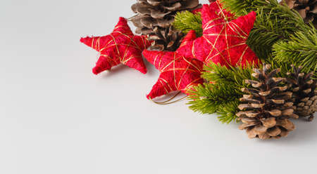 New Year and Christmas scene decoration with pine, cones and stars on white backgroundの写真素材