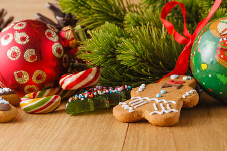 New year decoration on wood table with pine, sweets and red stars