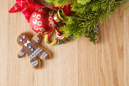 New year decoration on wood table with pine, sweets and red starsの写真素材