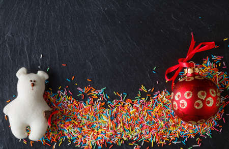 Christmas Day invitation card with sweets on black slateの写真素材