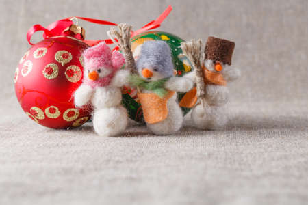 Handmade felt snowmans with christmans ballsの写真素材