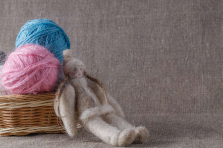 Homemade doll and colored clew in backedの写真素材