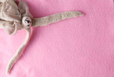 Kid greeting card concept. Felt doll on colorful background wit copy spaceの写真素材