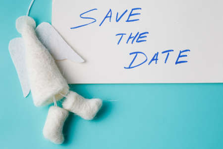 Felt angel with message save the date on aquamarine backgroundの写真素材