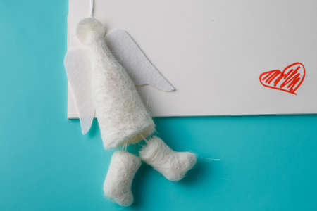 Felt angel with message save the date on aquamarine backgroundの写真素材