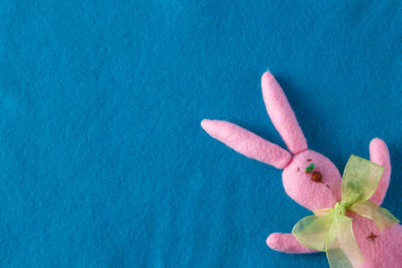 Kid toy play concept. Frame with soft felt and handmade funny pink rabbitの写真素材