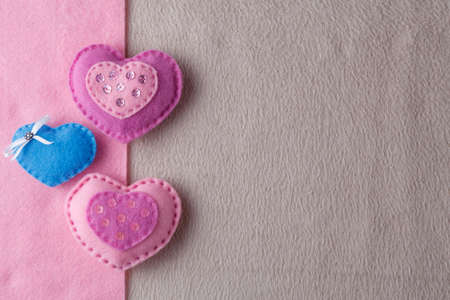 soft handmade felt background with heartsの写真素材
