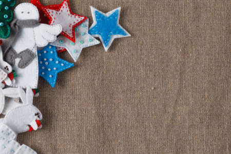 Christmas decoration. Flat felt figures on coarse wovenの写真素材