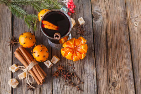 Heating winter drinks. Female hold glass of hot mulled wineの写真素材