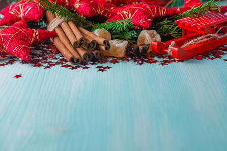 Winter symbols frame. Aquamarine background with winter hot spices, mandarine and starsの写真素材