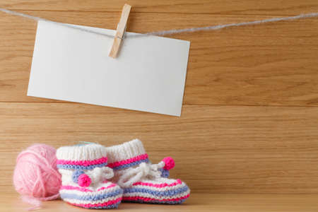 Newborn booties for christening or birthday invitation announcementの写真素材