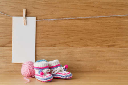 Newborn booties for christening or birthday invitation announcementの写真素材