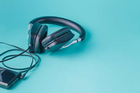 Headphones with misic player on plain aquamarine backgroundの写真素材