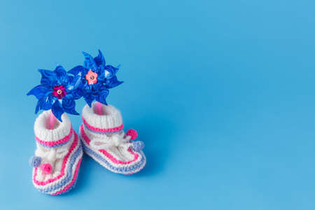 Newborn announcement template. Handmade knitted booties  with toyの写真素材