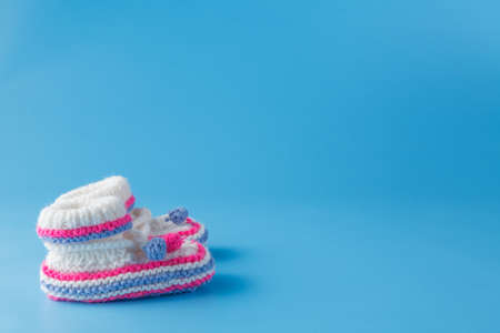 Newborn announcement template. Handmade knitted tiny bootiesの写真素材