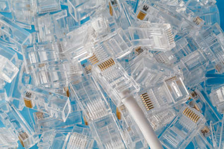 Heap of network connectors on blue backgroundの写真素材