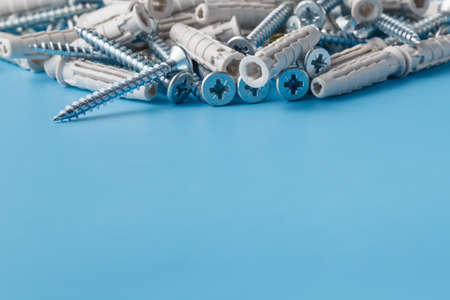 Group of screws on plain blue background with copyspaceの写真素材