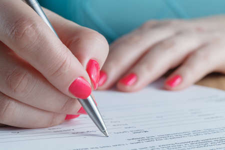 Woman signing contractの写真素材