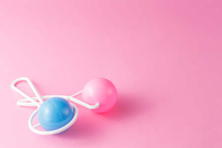 Plastic Retro Rattle. Baby toys on pink bakground.