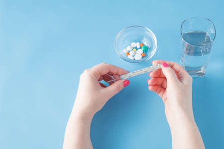 Drugs on blue background. Concept treatment fever