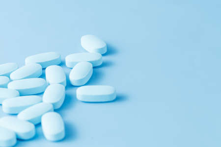 Blue medicine painkiller on blue background