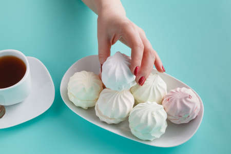 Women pick pastel colored marshmallow for breakfastの写真素材