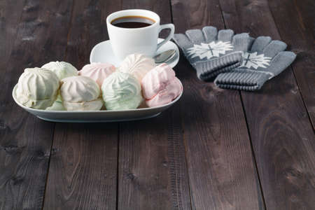 Coffee cup and marshmallow on wooden tableの写真素材