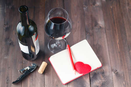 Wine bottles with glass, wooden backgroundの写真素材