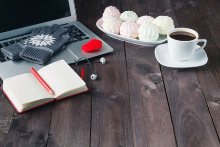 working at night, laptop and cup of coffee on tableの写真素材