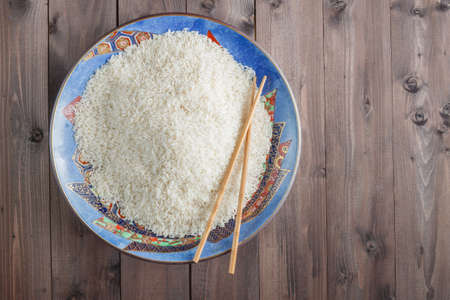 White rice on a plate, big spoon on the sideの写真素材