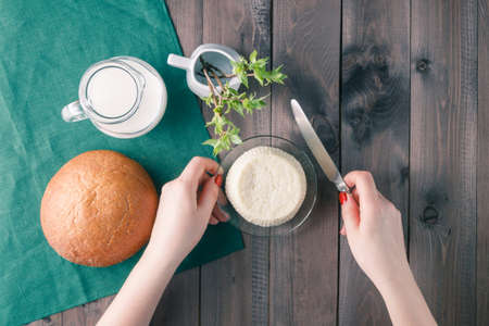 Fresh feta cheese with milk and bread on a wooden table