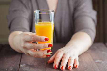 Woman offering orange juiceの写真素材