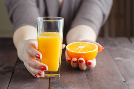 Woman offering orange juiceの写真素材