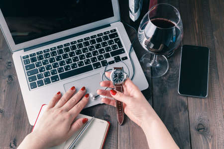 woman working on laptop and drinking wineの写真素材
