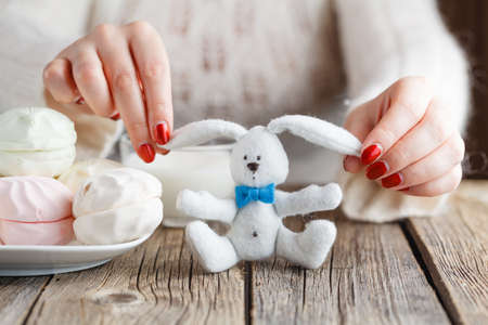 Woman offer red toy heart and eat sweetsの写真素材