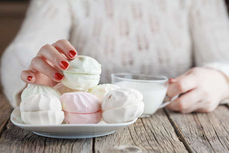 Woman drinking milk and eating sweets