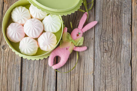 marshmallow in a gift box on a rustic background with note save the dateの写真素材