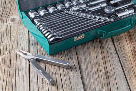 Tools in box on wooden background