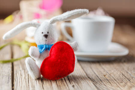 White rabbit and red heart on table, birthday presentの写真素材