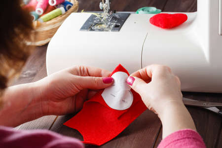 Sewing Process - Women's hands behind her sewing, toy made
