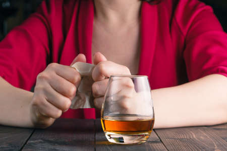 woman crush paper note and drink alcoholの写真素材