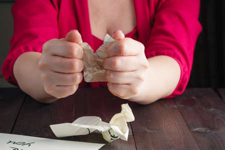 Woman crush bad letter on wooden tableの写真素材