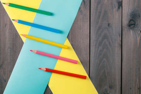 pencilee with crosser color band on rustic wooden tableの写真素材