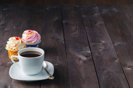 Cupcake and coffee on dark rustic tableの写真素材