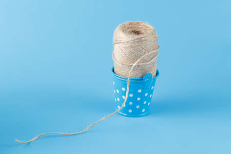 natural twine in blue bucked on plain backgroundの写真素材