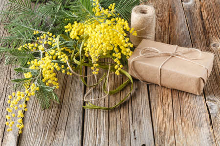 top view paper wrapped gift with yellow spring flowersの写真素材