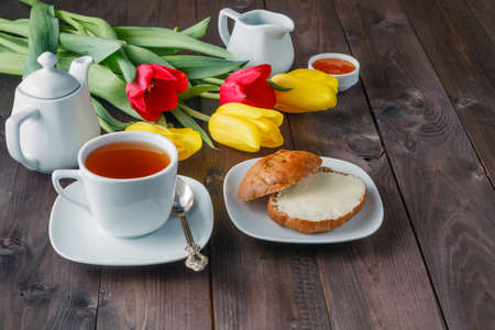 breakfast, morning. Red tulip cup of teaの写真素材