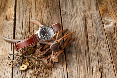rust watch gear on dark wooden table